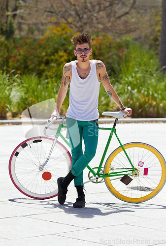 Image of Portrait, bike and a hipster man in the city for eco friendly travel, sustainability or carbon neutral transportation. Fashion, retro and a cyclist standing with a vintage bicycle in an urban town