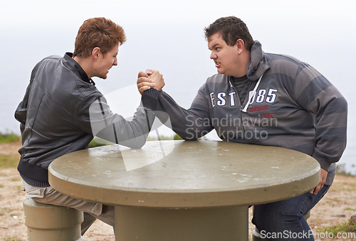 Image of Sport, friends and competition with men and arm wrestling in nature for challenge, power and respect. Team, strong and conflict with people and holding hands for muscle, match and rival match