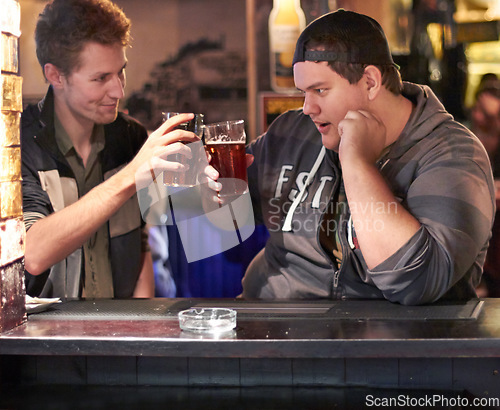 Image of Friends, beer and cheers with man at pub for conversation, social and alcohol. Nightlife, toast and restaurant with people talking at table in bar for discussion, celebration and weekend gathering