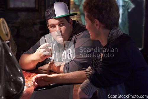 Image of Friends, beer and drink with man at pub for conversation, social and alcohol. Nightlife, relax and restaurant with people talking at table in bar for discussion, brewery and weekend gathering