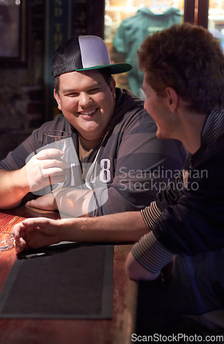 Image of Friends, beer and happy with man at pub for conversation, social and alcohol. Nightlife, relax and restaurant with people drinking at table in bar for discussion, brewery and weekend gathering