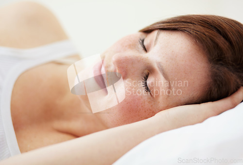 Image of Rest, sleeping and woman in bed, peaceful and enjoying a calm nap in her home. Eyes closed, dreaming and female person in a bedroom for snooze, cozy and comfort alone on the weekend in a house