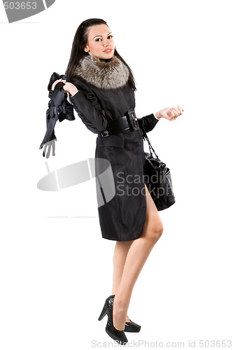 Image of The young woman in a black coat. Isolated on white