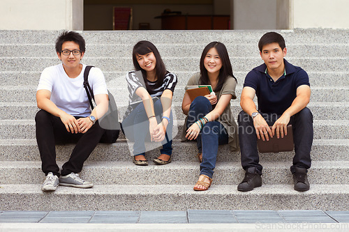 Image of Asian friends, portrait and university on stairs with smile, learning or gen z fashion at campus in Tokyo. Young student group, Japanese men and women with books, education or relax outdoor on steps