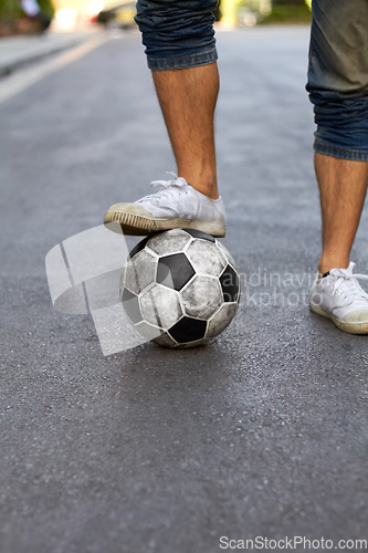 Image of Ready, street and feet of a person for soccer, game and training for sports. City, sneakers and legs of a man with a football for sport, exercise and urban fitness in the road while playing a match