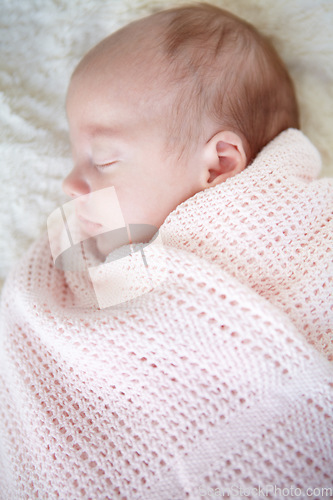 Image of Baby, closeup and sleeping on bed, blanket and tired in profile in family home for growth, peace and comfort. Newborn infant girl, exhausted and childhood development in nursery, bedroom and house