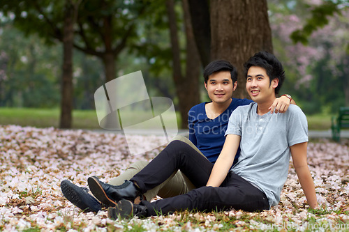 Image of Gay, Asian men and couple in park, nature date and life together with homosexual, pride and happiness. Young male people relax outdoor in Korea, LGBT and romance with trust in relationship and love