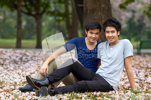 Image of Asian, gay and men in park, portrait of couple on nature date and life together with homosexual, pride and happiness. Young male people relax outdoor in Korea, LGBT and romance, relationship and love