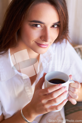 Image of Portrait, woman drink her coffee in the morning and thinking on sofa in the living room of her home. Peace or freedom, mindfulness or relax and female person drinking hot beverage for stress relief
