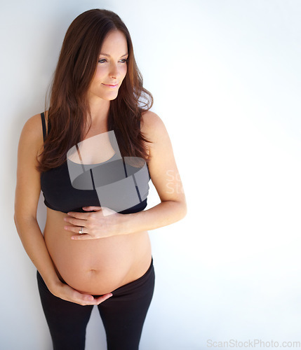 Image of Thinking, pregnant and woman touching her stomach, future and health with wellness, nurture and growth. Female person, mother and girl with pregnancy, belly and ideas with happiness and development