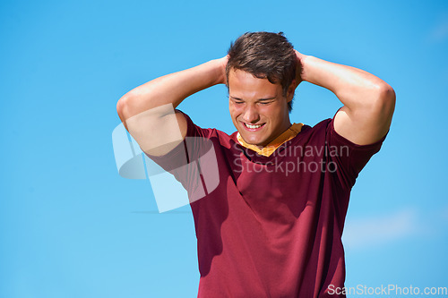 Image of Face, rugby and happy athlete in training, exercise or workout in sport practice on blue sky background. Sports, man and player with hands on head, thinking or idea for fitness, game and performance