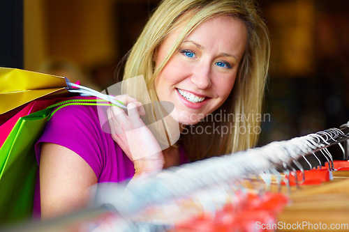 Image of Happy, retail and portrait of a woman doing shopping, discount and clothes search in a store. Smile, fashion and a real person with bags from a boutique, buying clothing and looking for a deal