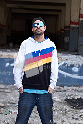 Image of Fashion, outfit and man with sunglasses in a city, chill and attitude, young and stylish on urban background. Trendy, glasses and male person with confidence, casual and cool clothes while downtown