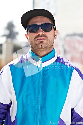 Image of Man, fashion and face with sunglasses in a city, chill and attitude, young and stylish on blurred background. Trendy, glasses and male person with confidence, casual and cool clothes while downtown