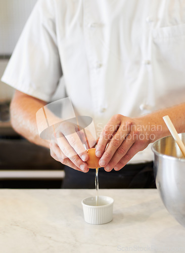 Image of Baker, cracking egg and hands with breakfast in the kitchen for health, protein and nutrition. Bakery, morning and a chef or person with food in a container for a dinner diet or restaurant cooking