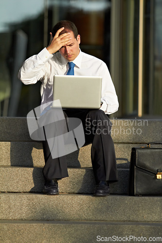 Image of Laptop, outdoor and business man stress, worry and sad for job fail, online mistake or news, bankruptcy and financial crisis. Person headache, debt and stock market crash on city stairs and computer