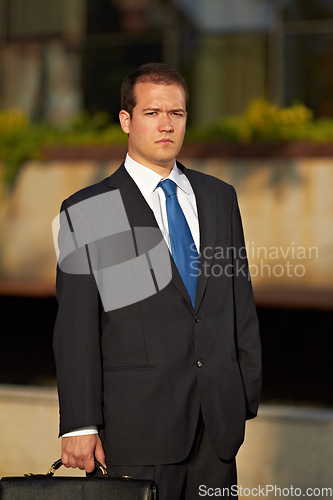 Image of Portrait, business and man in a city, serious and executive with formal wear, finance and professional. Male person, company director and employee with a briefcase, accounting and financial adviser