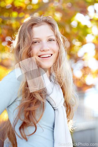 Image of Happy, ginger and portrait of child in nature during autumn for play, outdoor fun and to relax. Smile, calm and young girl or teenager in garden or backyard during fall season for carefree childhood