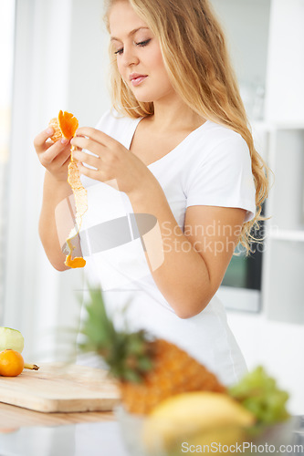 Image of Fruits, orange or woman with a healthy snack, breakfast meal or lunch diet in kitchen at home. Morning, digestion or girl eating fruit to lose weight for wellness, vitamins or gut health benefits