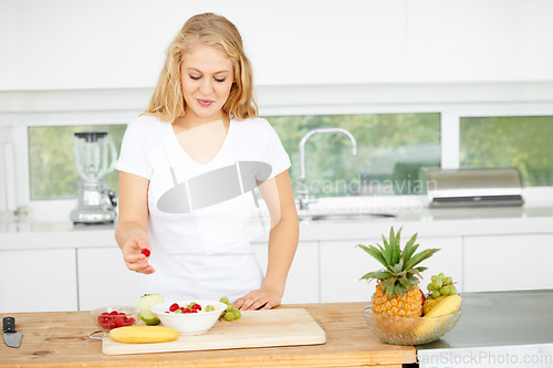 Image of Fruit salad, eating berries or woman with a snack, morning breakfast or lunch diet in home kitchen. Meal, gut health or happy vegan girl with fruits, grapes or food bowl to lose weight for wellness
