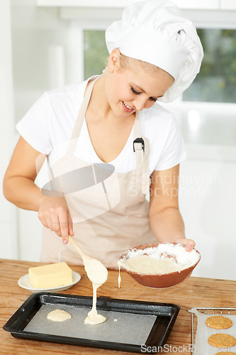 Image of Happy woman, bakery or chef baking cookies with dough or pastry in a kitchen and is happy decorating his recipe. Food business, dessert or girl baker working in preparation of a sweet meal or biscuit