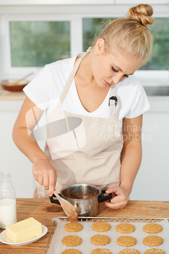 Image of Woman, kitchen or chef baking cookies with dough or pastry pot in a bakery shop with a dessert recipe. Food business, start or girl baker working in preparation of a sweet meal, cake or biscuits
