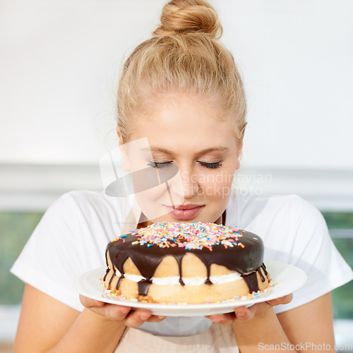 Image of Smelling, cake and girl is holding dessert for celebration with chocolate and sprinkles with scent at a bakery. Female baker, birthday and food with pastry for party or eating a sweet meal with cream