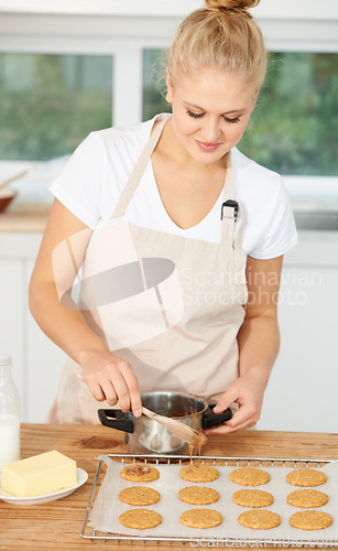 Image of Woman, kitchen or baker baking cookies with dough or pastry pot in a bakery shop with a dessert recipe. Food business, start or girl chef cooking in preparation of a sweet meal, cake or biscuits