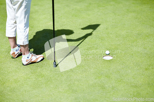 Image of Flag, shoes or person playing golf for fitness, workout or exercise with ball shadow on a green course. Legs of golfer, golfing or feet of athlete training or exercising in a sports game or practice