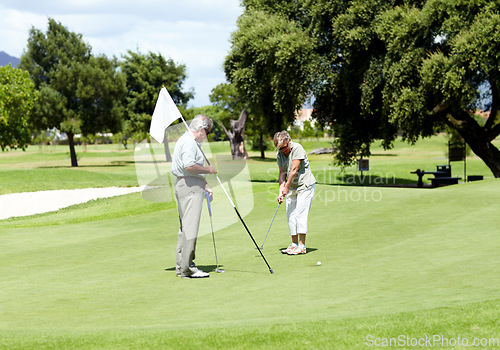 Image of Man with flag, old woman or golfer on golf course for a birdie, putting stroke or exercise in retirement. Senior couple, mature or serious player training in golfing sports game driving with a club