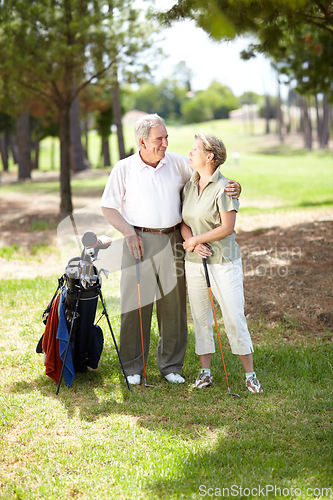 Image of Happy old couple, love or golfers on course in fitness workout, exercise or round together on grass field. Embrace, healthy elderly man hugging or smiling in golfing sports game with senior woman