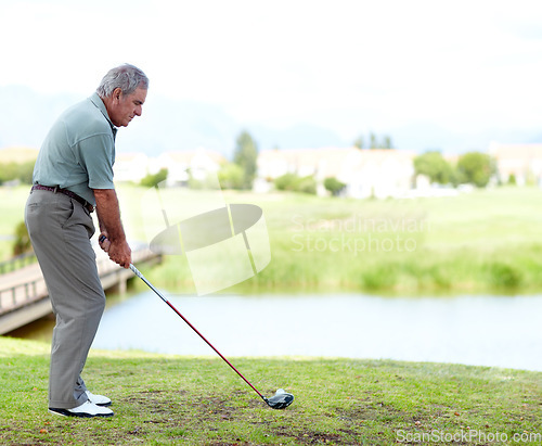 Image of Senior, man or golfer playing golf for fitness, workout or exercise with a swing on a green course. Stroke, person golfing or mature player training in sports game driving with a club in retirement