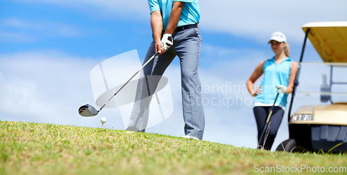 Image of Low angle, man or golfer playing golf for fitness, workout or exercise to swing with driver on course. Ball, person golfing or hands of athlete training in sports game driving with a club stroke