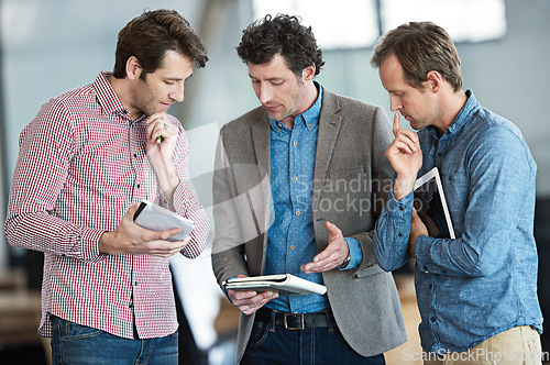 Image of Tablet, team discussion or business people thinking of ideas in group meeting for brainstorming in office. Research, collaboration or developers talking or planning a project strategy in workplace