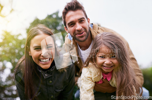 Image of Family, laughing and park with face of parents, dad and girl together with mom and smile. Outdoor, portrait and vacation of a mother, father and kid with bonding, parent love and young child care