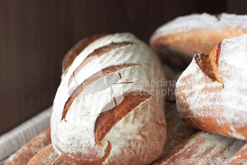 Image of Background, sourdough bread or closeup in bakery of fresh loaves, carbs and rustic grain for nutrition. Artisan confectionery, food industry or selection of baked buns in cafe, grocery store or diner