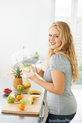 Image of Fruit, peeling apple or portrait of woman with a morning snack, breakfast meal or diet in kitchen at home. Healthy lunch, plus size or happy girl eating food to lose weight for wellness or gut health