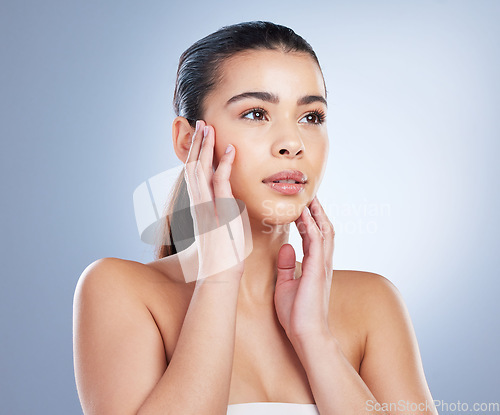 Image of Skincare, woman and hands on face in studio for wellness, glowing skin or cosmetic satisfaction on grey background. Beauty, soft and asian lady model touching dermatology, luxury or treatment results