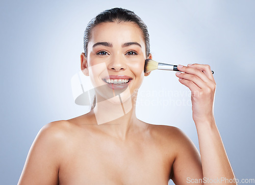 Image of Makeup, portrait and happy woman with brush in studio for cheeks, cosmetics and application on grey background. Face, smile and female wellness model with tool for beauty, glamour or contour results