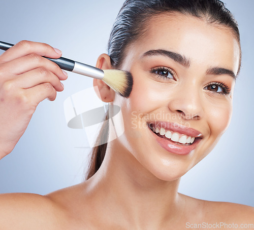 Image of Beauty, cosmetic and portrait of woman with a makeup brush in studio for glamour facial routine. Self care, happy and young female model from Brazil with cosmetology face isolated by gray background.