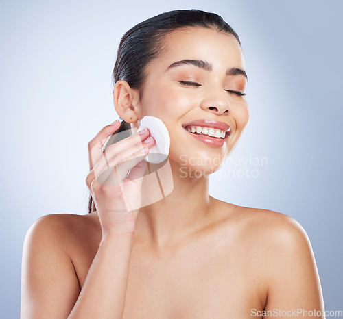 Image of Skincare, pad and asian woman in studio for makeup removal, toner or hydration on grey background. Smile, beauty and asian lady wellness model with facial cotton for cleaning or glowing skin routine
