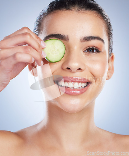 Image of Cucumber, skincare and asian woman portrait in studio happy for wellness or anti aging on grey background. Fruit. detox and lady face model smile for antioxidants, facial or beauty mask treatment