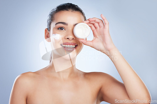 Image of Skincare, portrait and happy woman with face cream in studio for anti aging, wellness or hydration on grey background. Facial, smile and asian female model with sunscreen, lotion or beauty cosmetics