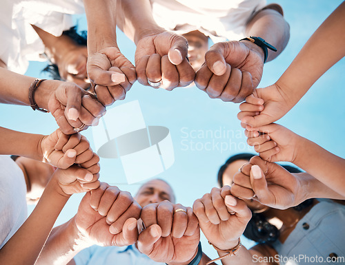 Image of Circle, hands and fist bump by people in support of collaboration, motivation and goal from below. Fingers, team building and group with emoji for power, trust and unity, teamwork and partnership