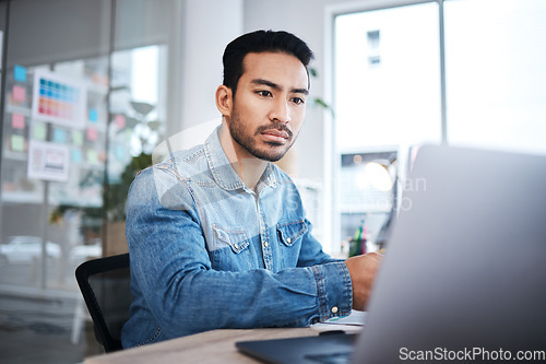 Image of Thinking, laptop and man at desk reading email, feedback or research planning at design agency job. Business, website and computer, employee in office checking online report at tech startup workshop.