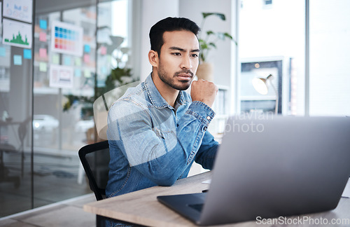 Image of Thinking, laptop and man at desk reading email, website or research planning at design agency. Business, brainstorming and problem solving, employee in office checking online report at startup job.