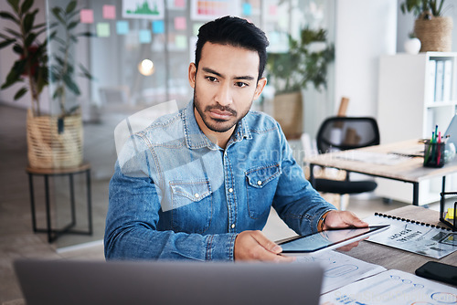 Image of Thinking, reading and man at desk with online report, laptop and digital research planning at design agency. Business, documents and tablet, employee with email or internet search at tech startup job