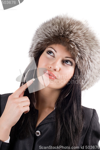 Image of Portrait of the young woman in a fur cap. Isolated on white back