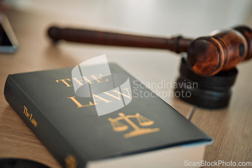 Image of Justice law book and gavel in court for truth, freedom and legal system for rights, faith and constitution. Courtroom, desk and expert guide for judge in knowledge, information and trust with hammer.