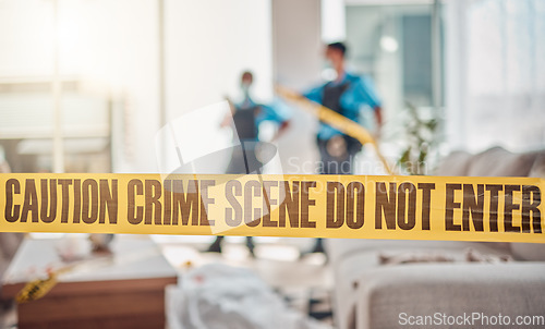 Image of Tape, crime scene and police in house for investigation, inspection and forensic analysis. Law enforcement, safety and security people in living room for criminal, murder and searching for evidence